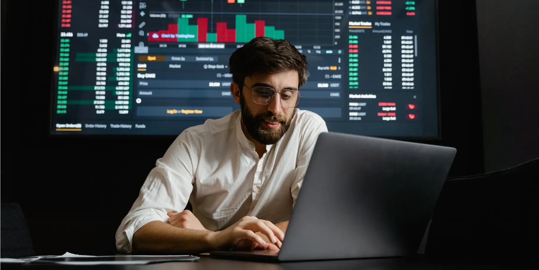 A man with his laptop and chart behind him